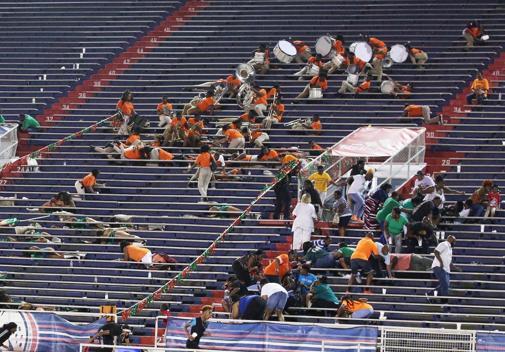 LeFlore fans and students take cover after gunfire rings out at the conclusion of the Williamson and LeFlore prep football game Friday, August 30, 2019, at Ladd-Peebles Stadium in Mobile, Ala. (Mike Kittrell/preps@al.com)