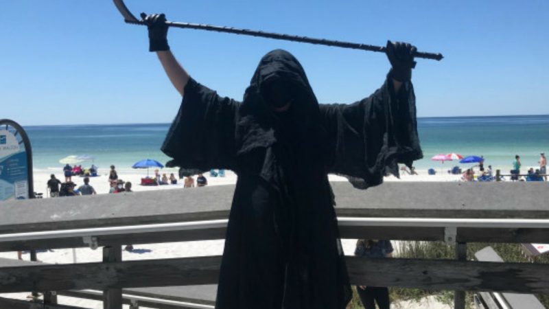 Grim Reaper Haunts Beaches To Protest Premature Reopening